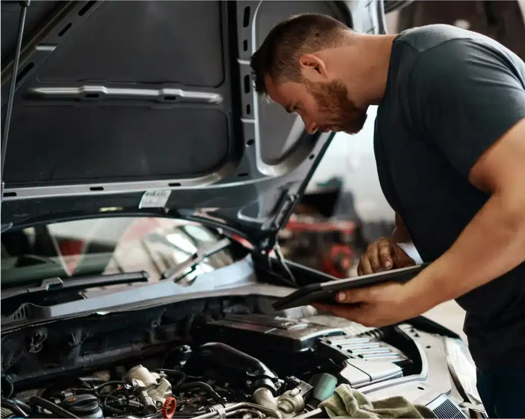 Pleasant Automotive Auto Diagnostic Services in Wake Forest, NC. A man looking at a tablet