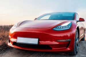 tesla services in wake forest, Auto Repair Services in Wake Forest, NC at Pleasant Automotive. An image of a red tesla parked outside with a scenic view.