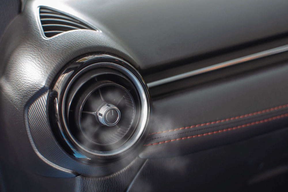 car a/c problems, Auto Repair Services in Wake Forest, NC at Pleasant Automotive. Image of a close-up car air conditioning vent releasing visible cool air, highlighting reliable A/C performance and climate control maintenance service