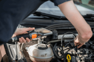 Vehicle diagnostics, auto repair in Wake Forest, NC by Pleasant Automotive. Image of a technician using a diagnostic scanner to inspect engine components, highlighting accurate troubleshooting, preventative maintenance, and dependable automotive repair services.