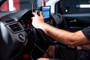 Vehicle diagnostics, auto repair in Wake Forest, NC at Pleasant Automotive. Image of a technician using a diagnostic scan tool inside a vehicle to identify electronic issues and support accurate, reliable repairs.