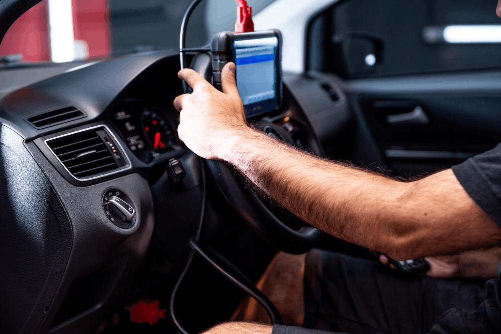 Vehicle diagnostics, auto repair in Wake Forest, NC at Pleasant Automotive. Image of a technician using a diagnostic scan tool inside a vehicle to identify electronic issues and support accurate, reliable repairs.